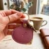 Personalized heart keychain with name in vegan leather. A cute personalized bag charm or keyring with elegant gold details, made in Amsterdam.