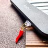 Spicy Kindle charm for smut and romance readers. Red chilli e-reader dust plug, Kobo and phone charm. A funny gift for spicy book lovers.