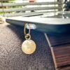 Elegant Pearl Kindle Charm with gold-tone detail. Minimalist e-reader dust plug, Kobo charm and phone charm for Kindle readers and book lovers.